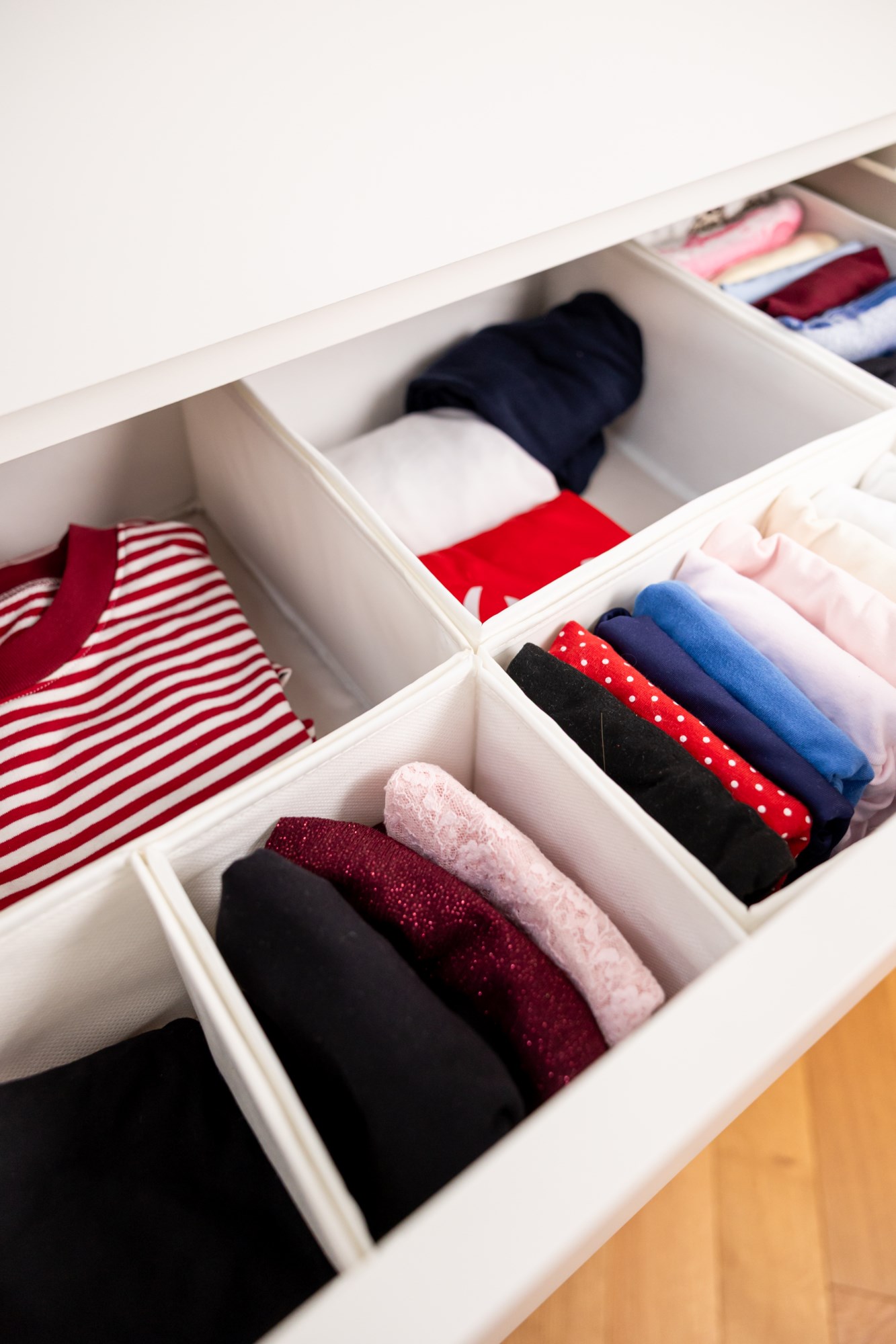 Neatly folded clothes in drawer dividers