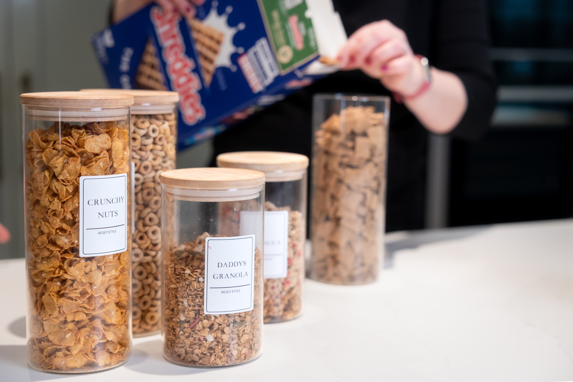Labelled cereal and granola jars on countertop