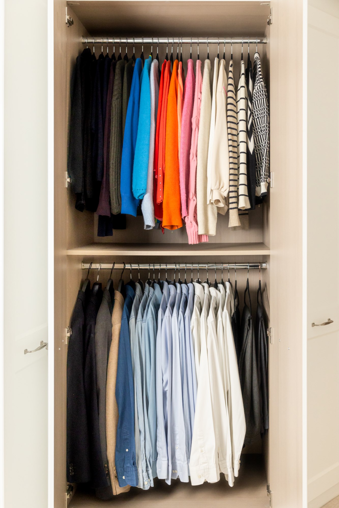 Organised wardrobe with colour-coordinated clothing